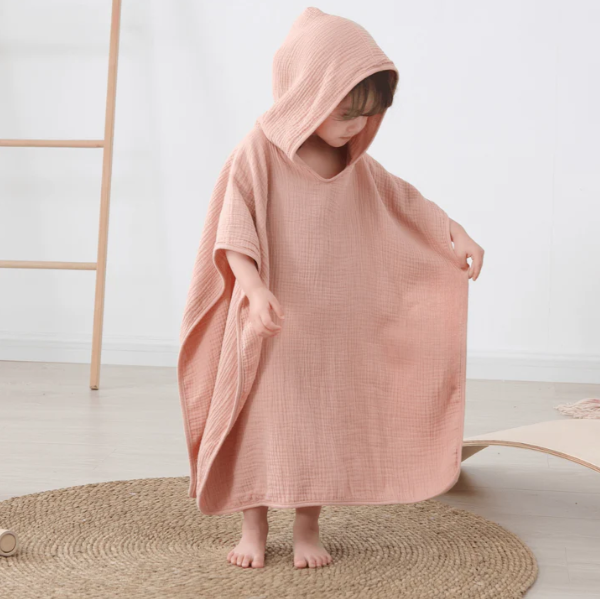 Ultra-soft muslin baby beach towel with storage pocket. Quick-dry 100% cotton for infants 0-24 months. Summer essential for beach/pool safety.